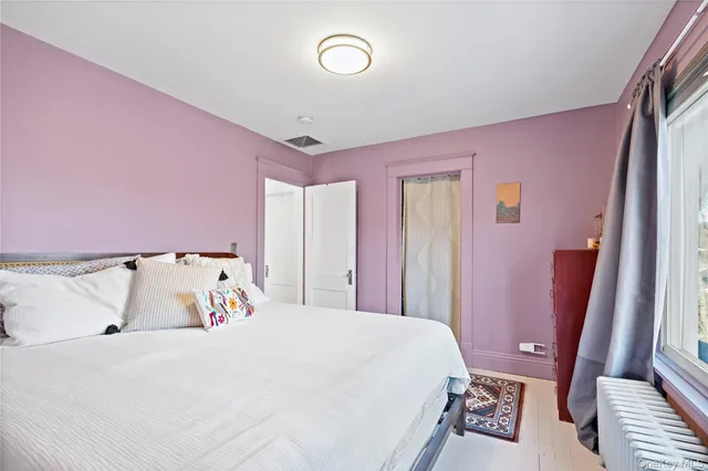 a bed room with a bed and a window