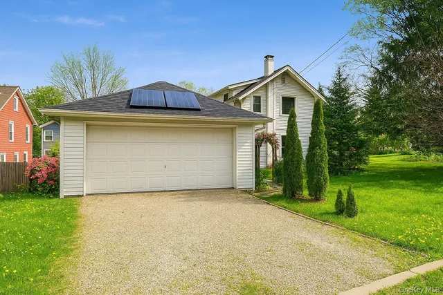 a front view of house with yard and green space