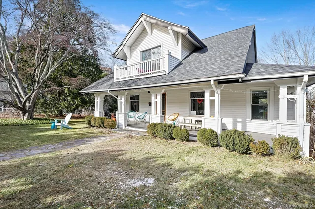 a front view of a house with a garden and porch