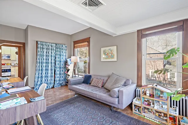 a living room with furniture and a book shelf