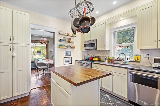 a kitchen with a stove a kitchen island a stove cabinets a dining table and chairs