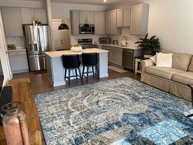 a kitchen with a sink a stove a refrigerator and chairs