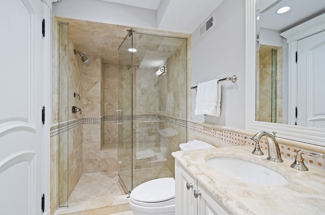 519 Willow Road Winnetka, IL 60093 - Photo 40 of 44 a bathroom with a sink a toilet and shower
