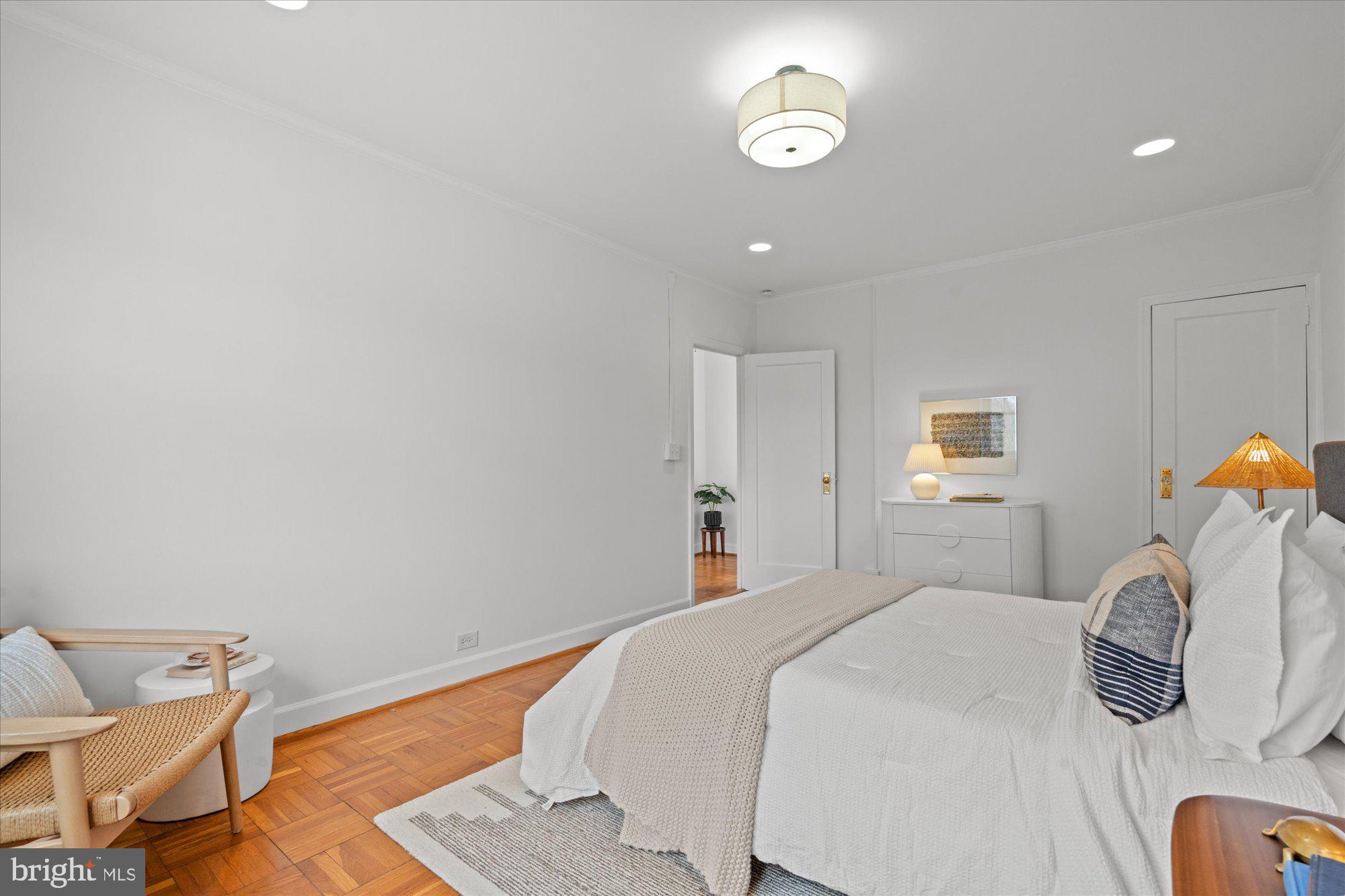3206 Gunston Road Alexandria, VA 22302 - Photo 17 of 25 a bedroom with a bed and a chair