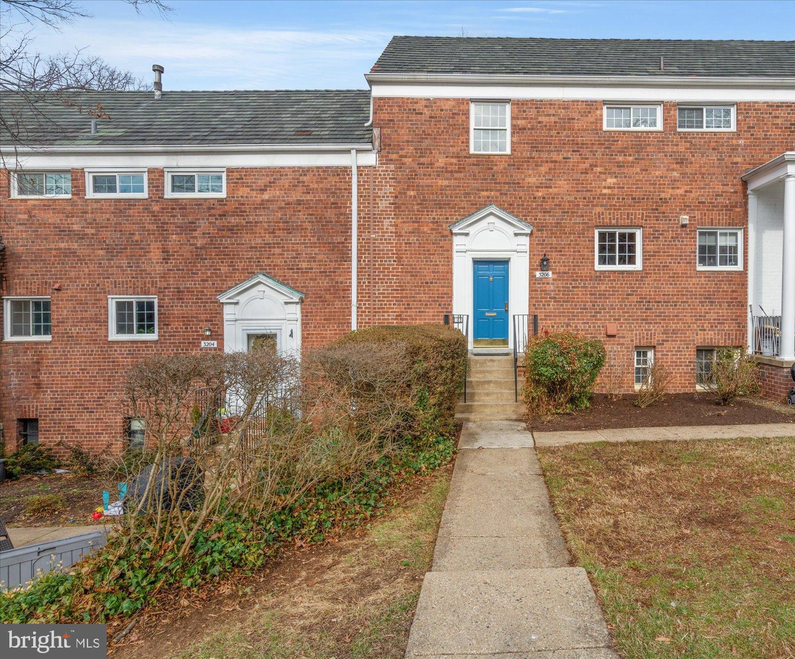 3206 Gunston Road Alexandria, VA 22302 - Photo 2 of 25 front view of a brick house with a yard