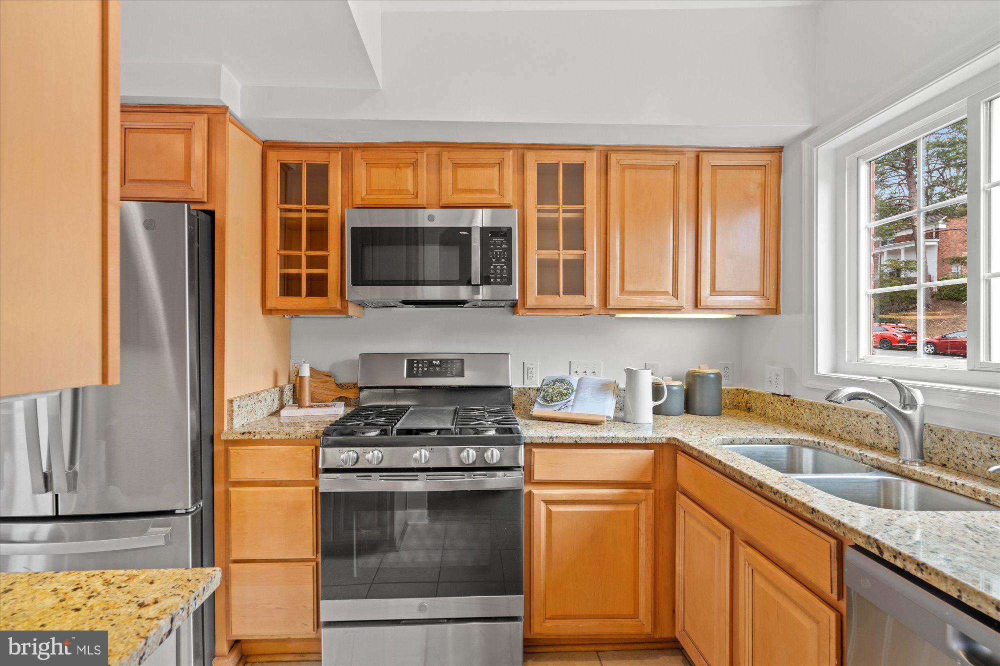 3206 Gunston Road Alexandria, VA 22302 - Photo 9 of 25 a kitchen with stainless steel appliances granite countertop a stove microwave refrigerator sink and cabinets