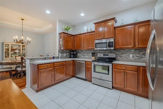a kitchen with stainless steel appliances granite countertop a stove sink and cabinets