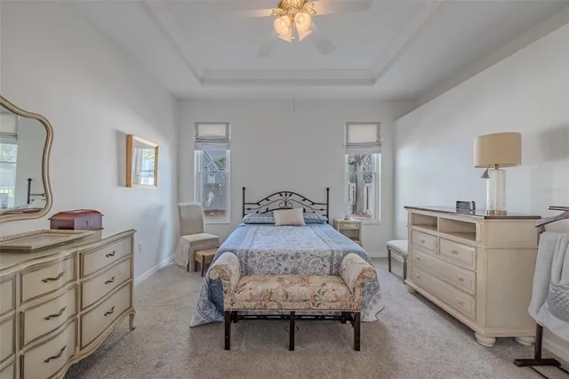 a spacious bedroom with a bed and a dresser in it