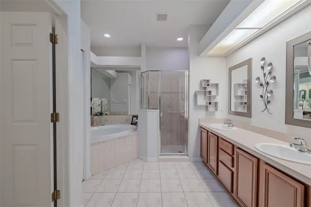 a spacious bathroom with a bathtub shower sink mirror and a bathtub