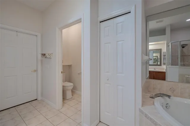 a bathroom with a granite countertop toilet a sink and bathtub