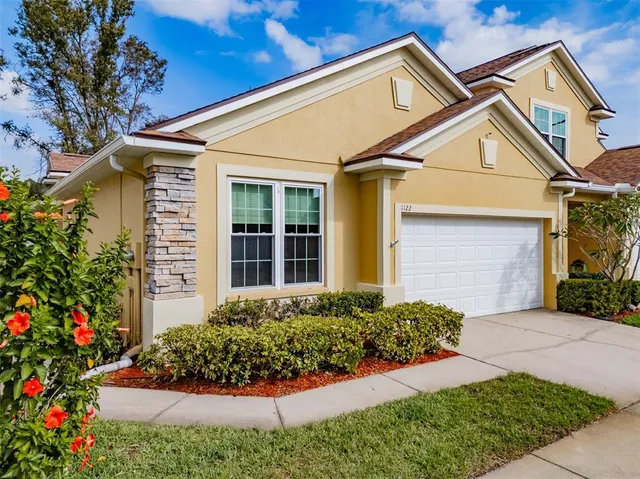 a front view of a house with plants