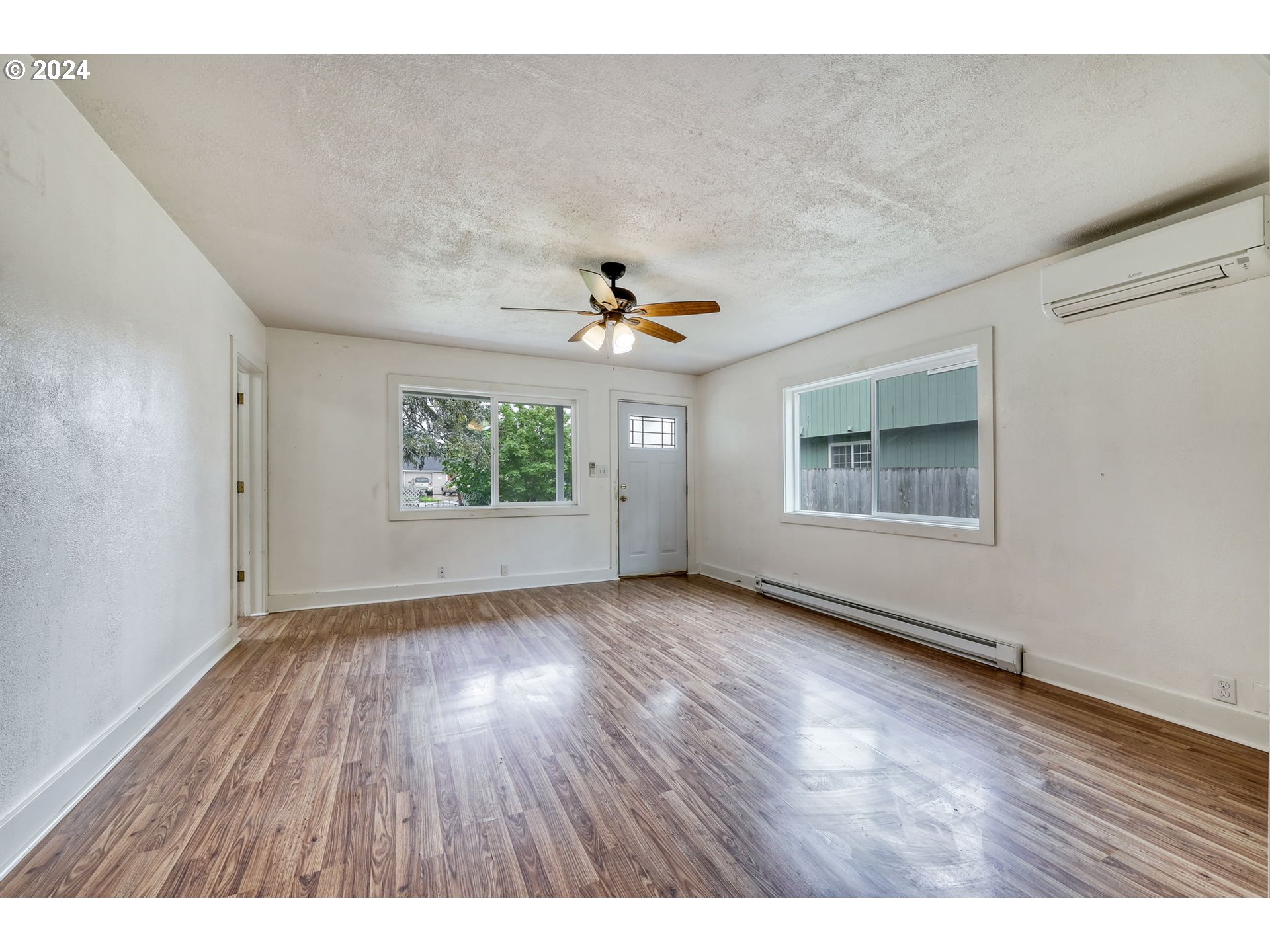 614 Mill Street Springfield, OR 97477 - Photo 8 of 37 wooden floor in an empty room with a window