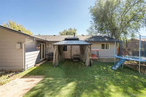 a view of a house with a yard and sitting area