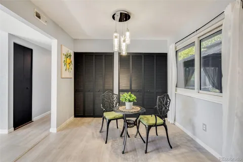 a view of a dining room with furniture and chandelier