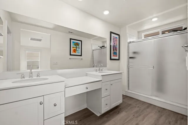 a spacious bathroom with a double vanity sink mirror and double