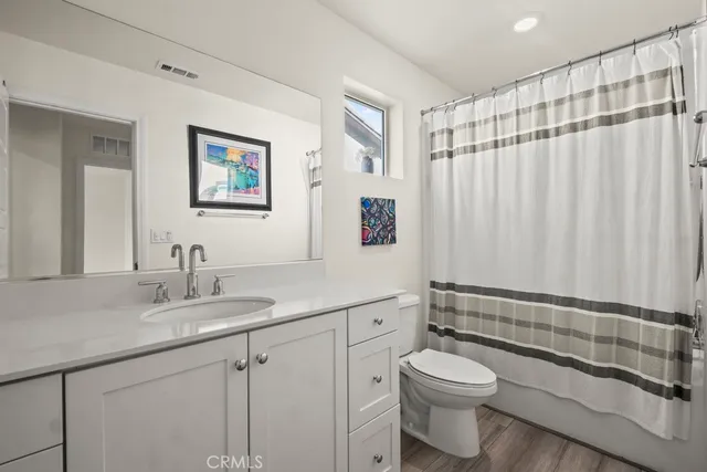 a bathroom with a toilet a sink and a mirror