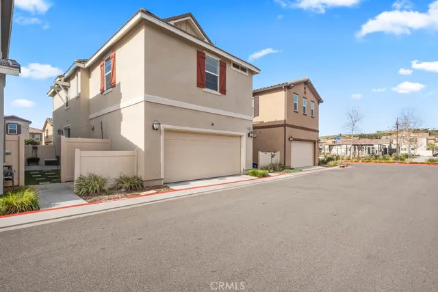 a front view of a house with a road and a garage