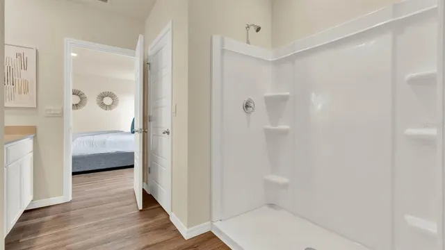 a bathroom with a tub shower and sink