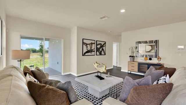 a living room with furniture a rug and a table