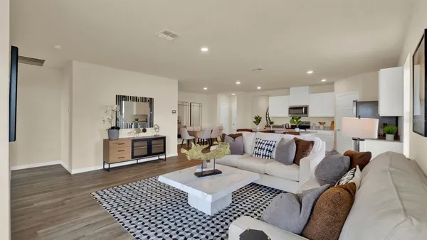 a view of a living room kitchen and a wooden floor