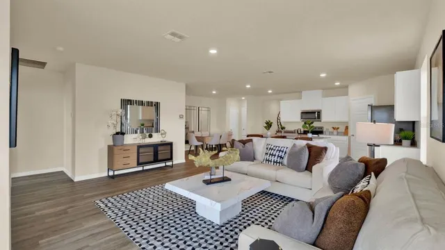 a view of a living room kitchen and a wooden floor