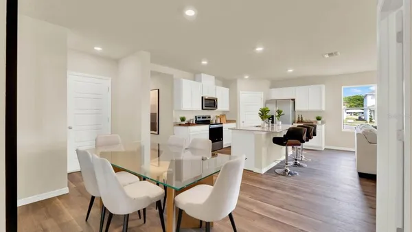 a view of a dining room with furniture and wooden floor