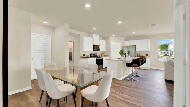 a view of a dining room with furniture and wooden floor