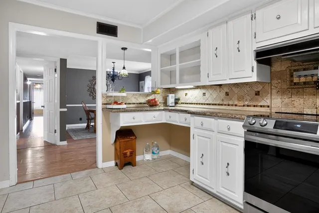 a kitchen with stainless steel appliances granite countertop a sink and cabinets