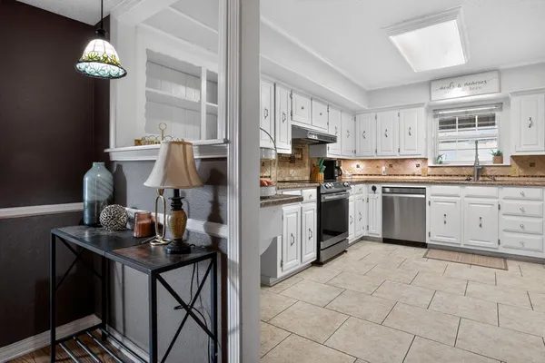 a kitchen with cabinets a sink and appliances