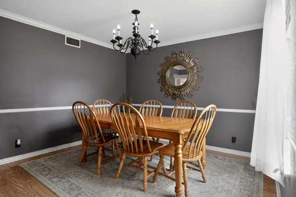 a view of a dining room with furniture and chandelier