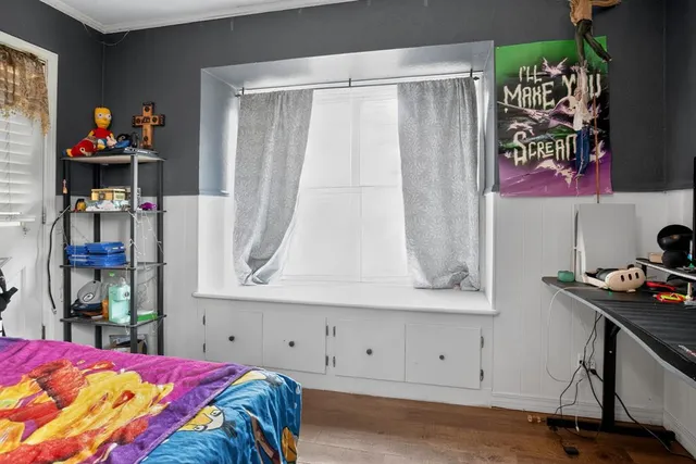 a bedroom with a bed and a window