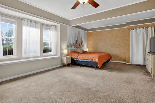 a bed sitting in a room next to a window