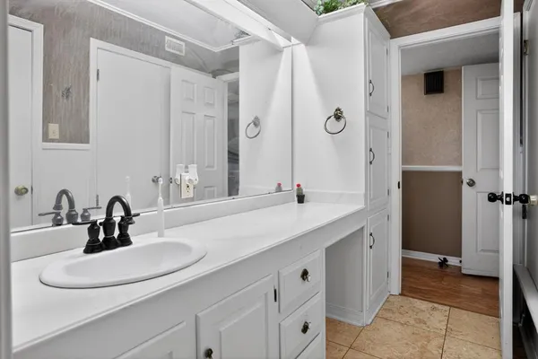 a bathroom with a double vanity sink and a mirror