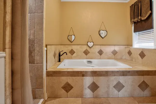 a bathroom with a bathtub and shower