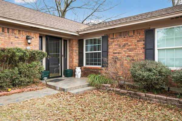 a front view of a house with garden
