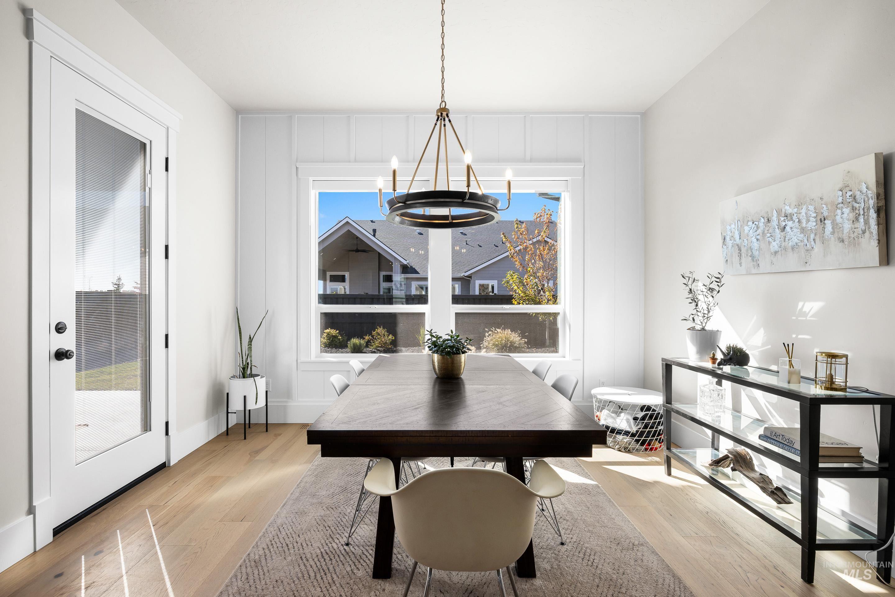 4217 North Bryant Way Meridian, ID 83646 - Photo 12 of 46 Dining area with light wood-style floors and a chandelier