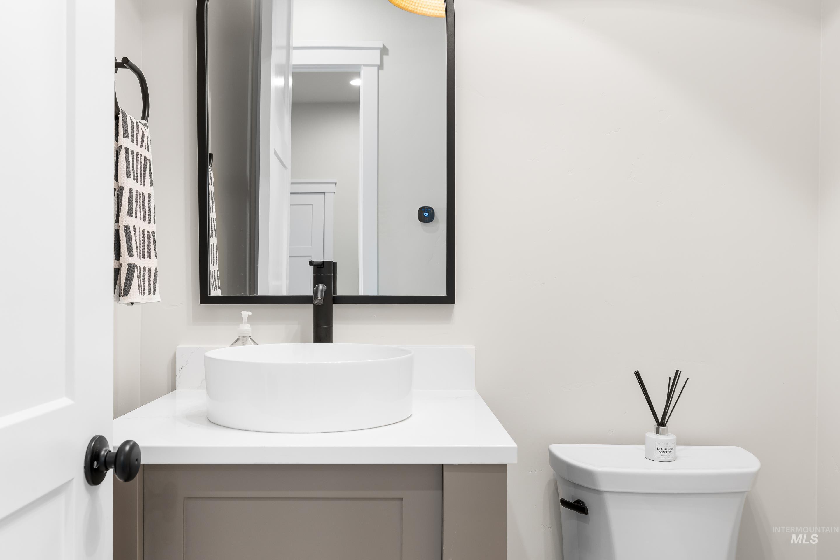 4217 North Bryant Way Meridian, ID 83646 - Photo 17 of 46 Half bathroom featuring vanity and toilet