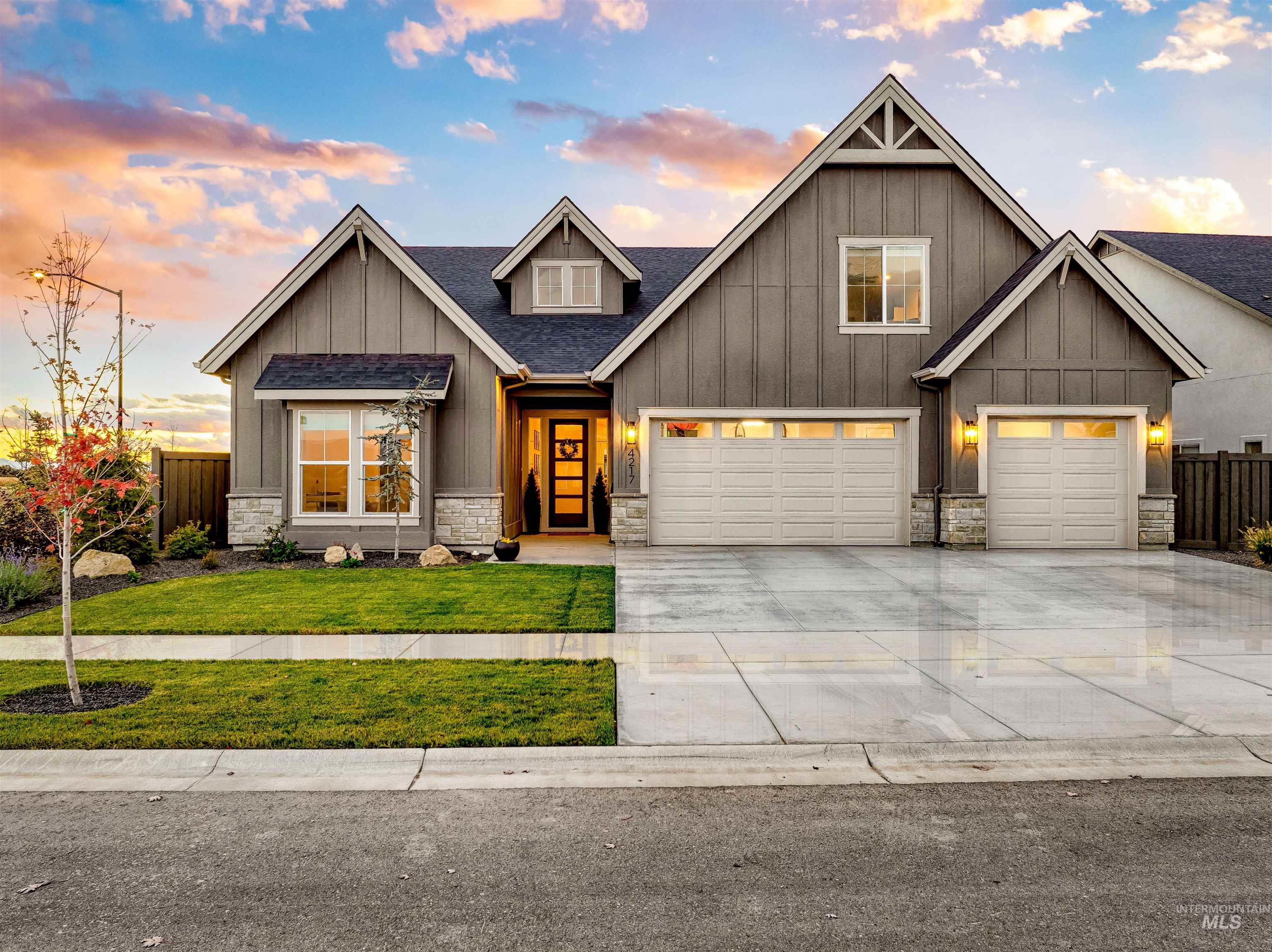 4217 North Bryant Way Meridian, ID 83646 - Photo 2 of 46 Craftsman-style house with stone siding, board and batten siding, driveway, and a shingled roof