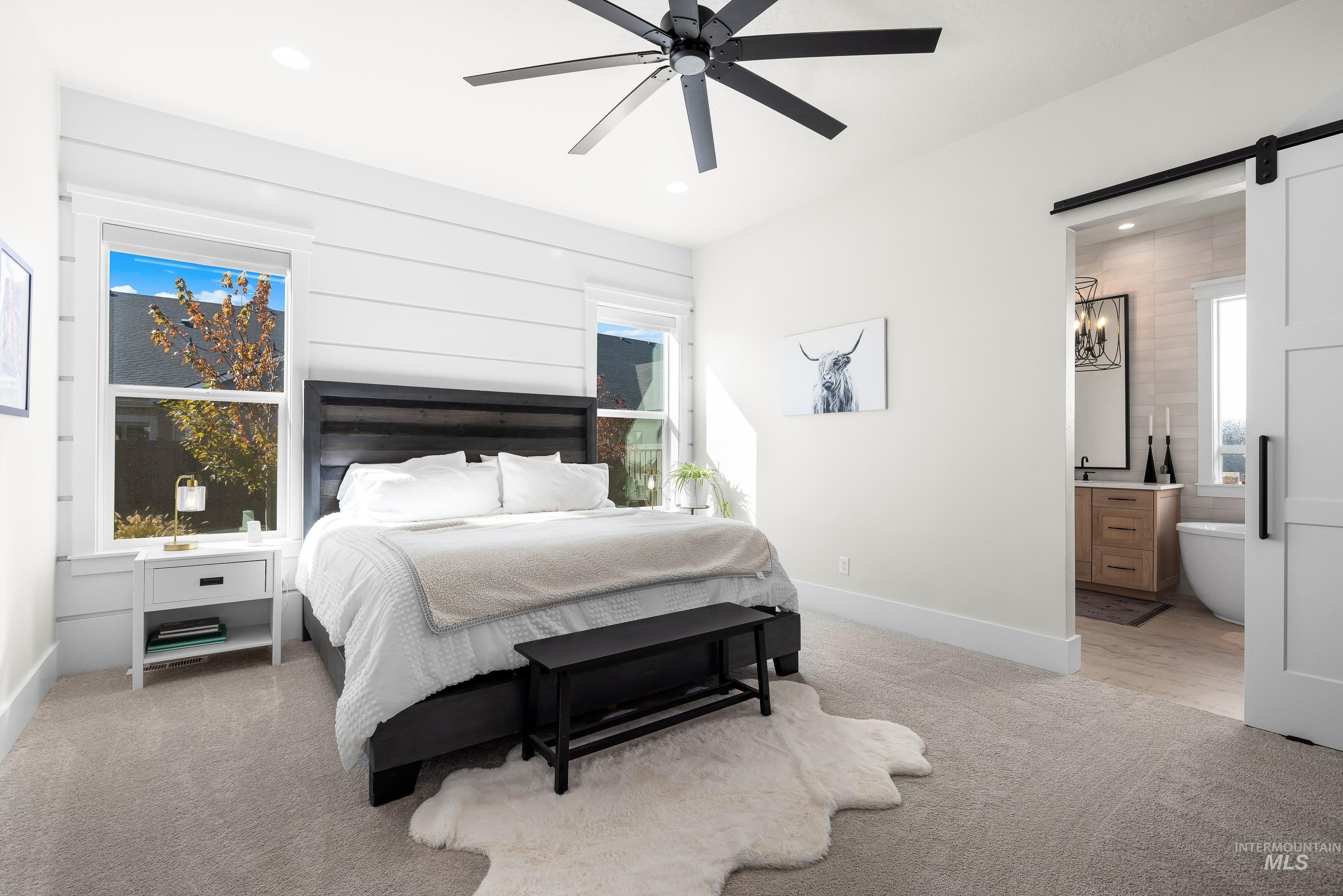 4217 North Bryant Way Meridian, ID 83646 - Photo 21 of 46 Bedroom with a barn door, light colored carpet, ceiling fan, connected bathroom, and recessed lighting