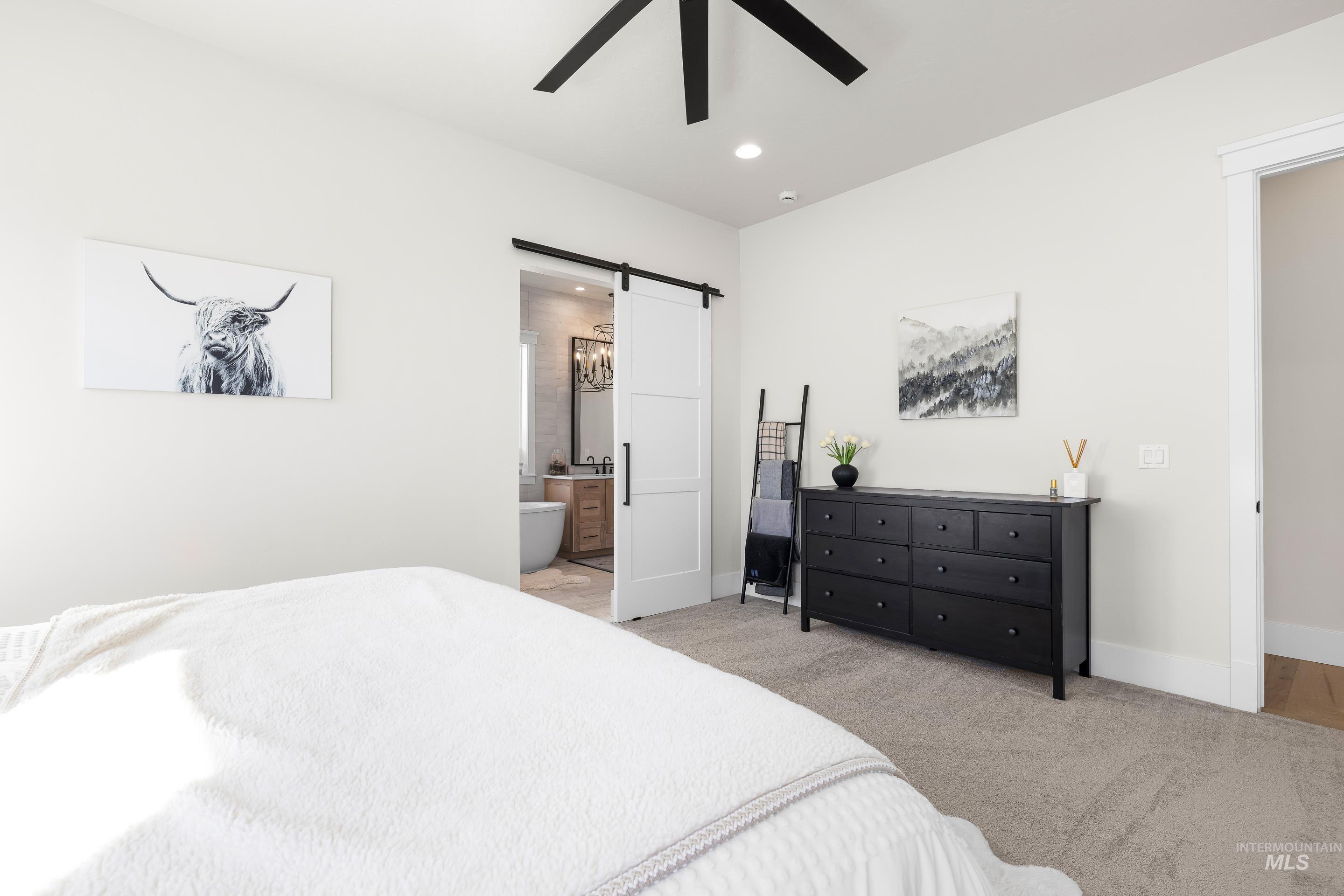 4217 North Bryant Way Meridian, ID 83646 - Photo 22 of 46 Bedroom featuring a barn door, light colored carpet, recessed lighting, ceiling fan, and ensuite bathroom