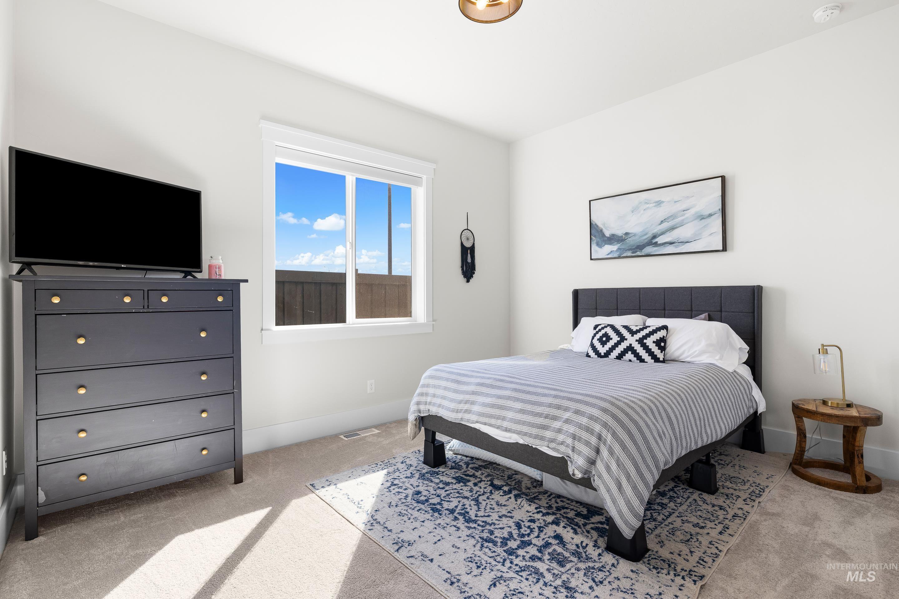 4217 North Bryant Way Meridian, ID 83646 - Photo 28 of 46 Bedroom featuring light colored carpet and baseboards