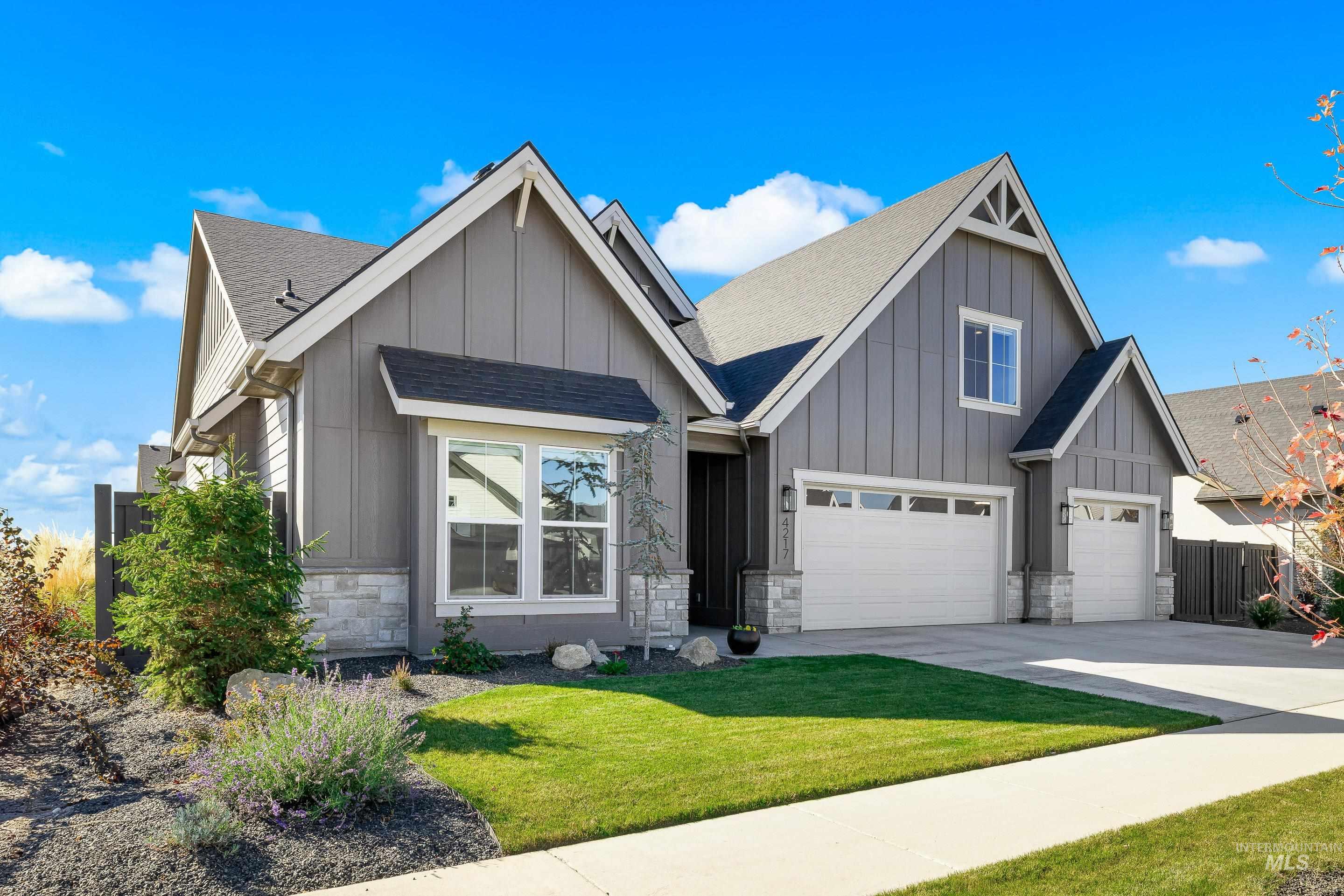 4217 North Bryant Way Meridian, ID 83646 - Photo 3 of 46 View of front facade featuring board and batten siding, a shingled roof, stone siding, and concrete driveway