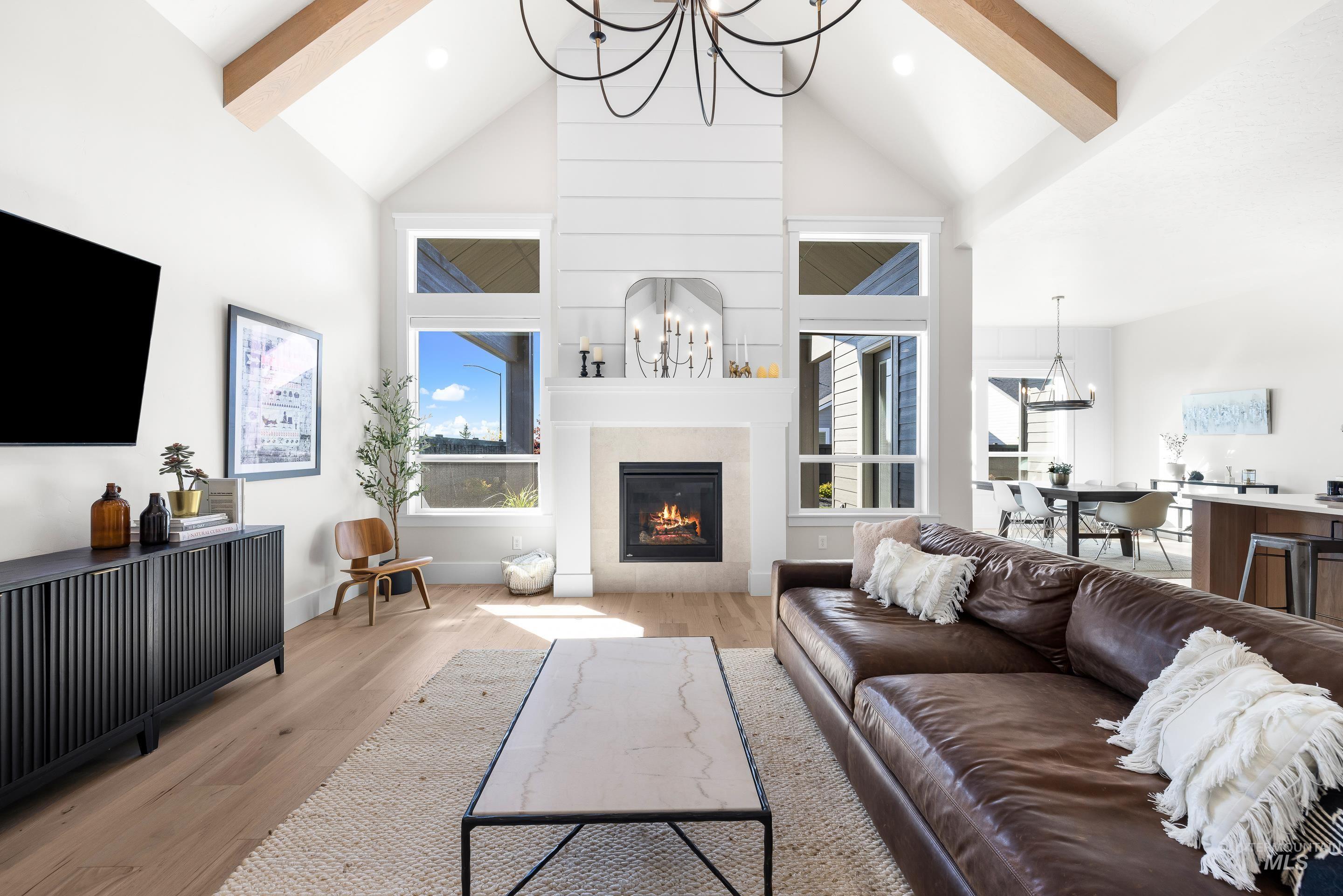 4217 North Bryant Way Meridian, ID 83646 - Photo 6 of 46 Living area with a chandelier, light wood-style floors, beam ceiling, plenty of natural light, and high vaulted ceiling