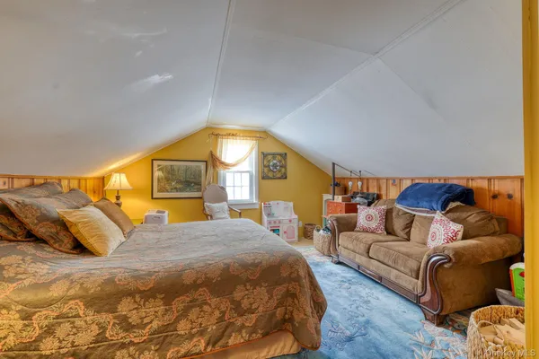 a bedroom with a bed and a couch