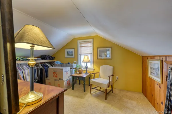 a view of a livingroom with furniture and a window