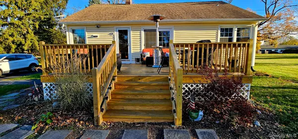a view of a house with backyard and sitting area