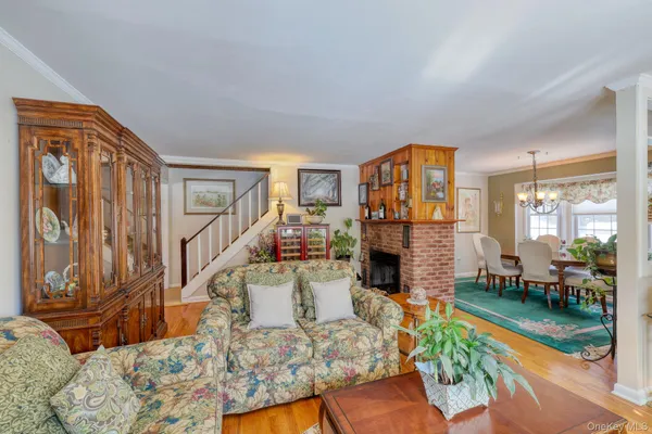 a living room with fireplace furniture and a floor to ceiling window