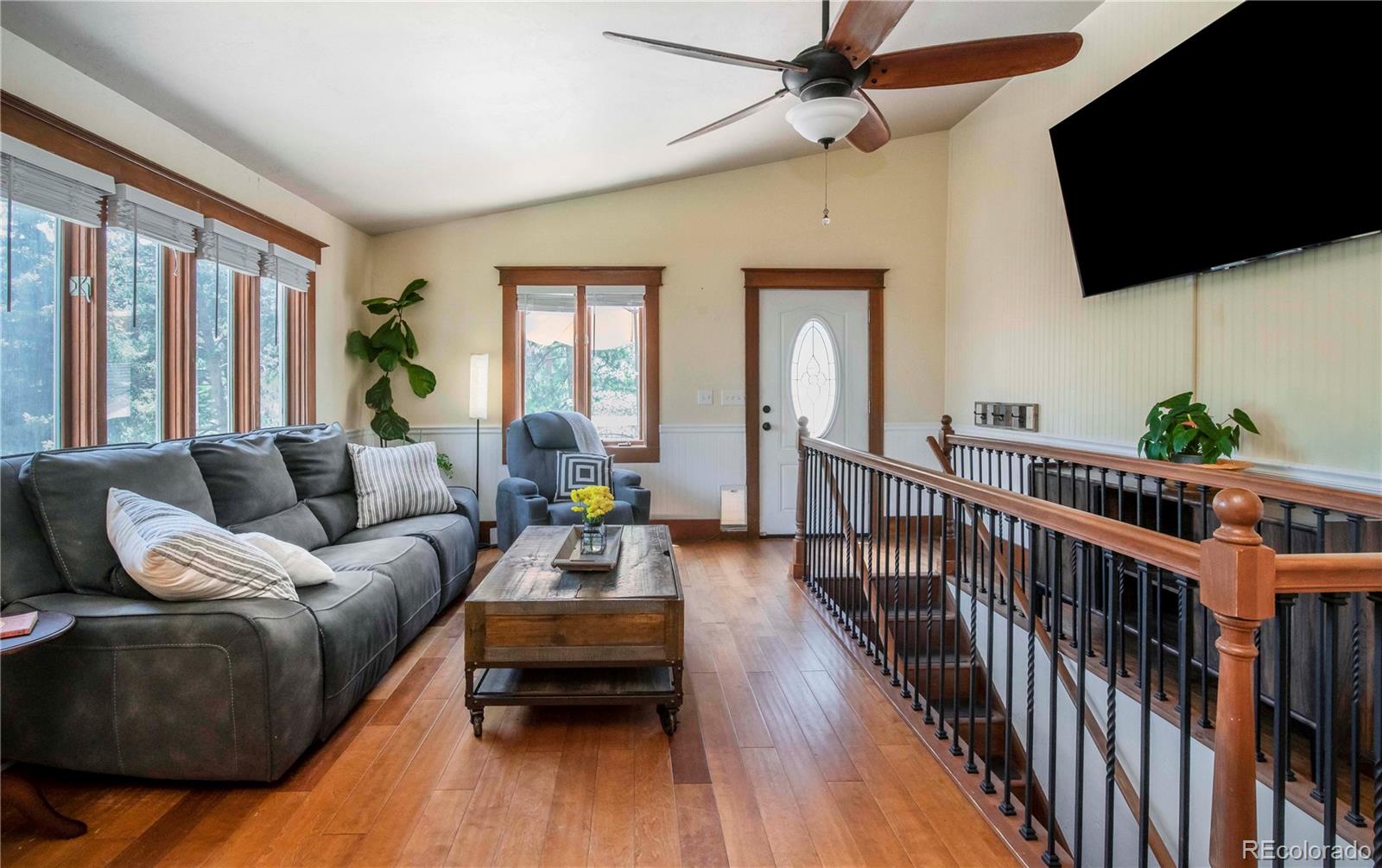 4805 Blue Spruce Road Evergreen, CO 80439 - Photo 11 of 43 a living room with furniture fireplace and a flat screen tv