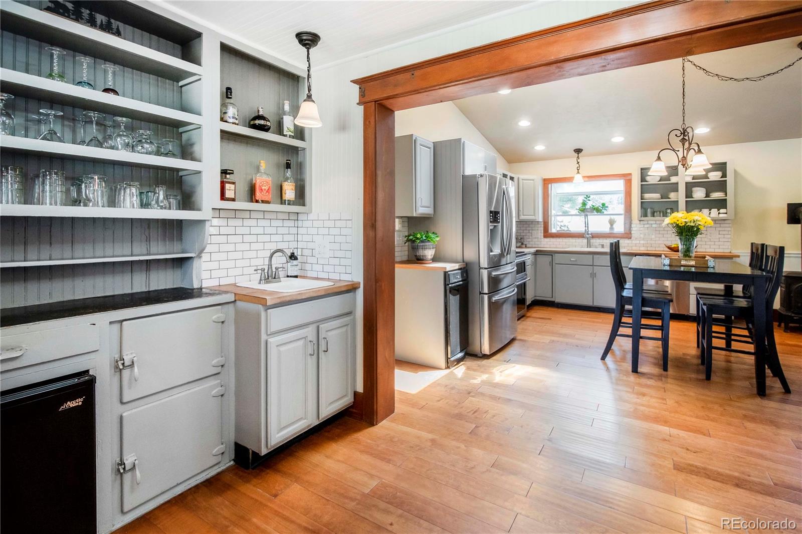 4805 Blue Spruce Road Evergreen, CO 80439 - Photo 13 of 43 a kitchen with stainless steel appliances granite countertop a table and chairs in it
