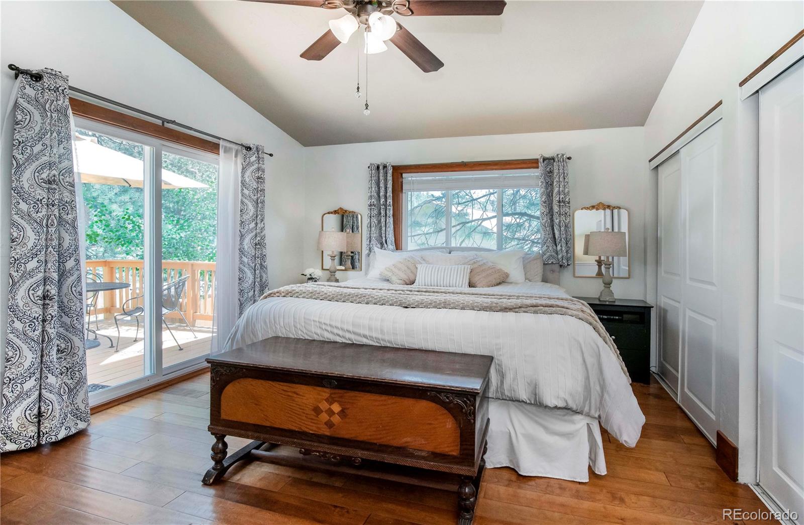 4805 Blue Spruce Road Evergreen, CO 80439 - Photo 15 of 43 a bedroom with a bed and wooden floor
